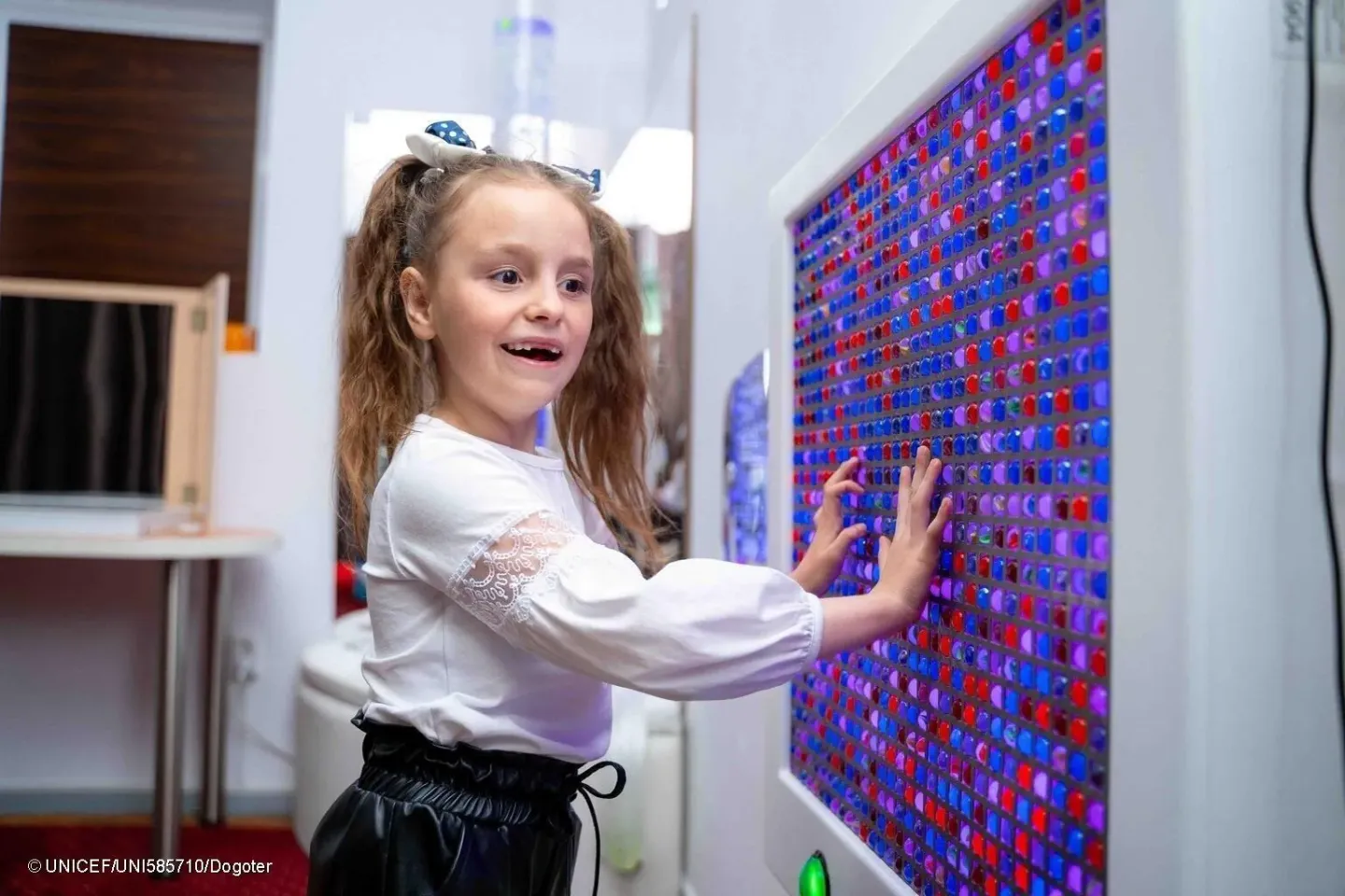 A girl participates in a therapy session in the sensory room established by UNICEF.