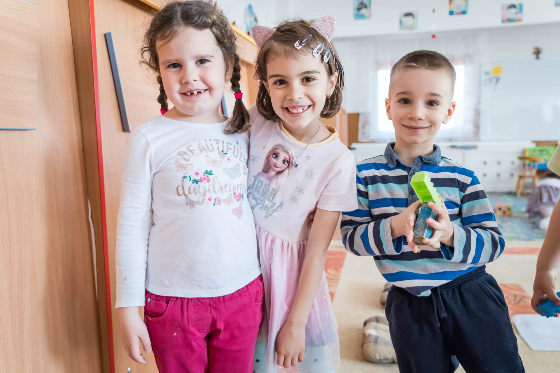 Children pose for a photo in a classroom in Kindergarten in Brasov, Romania.