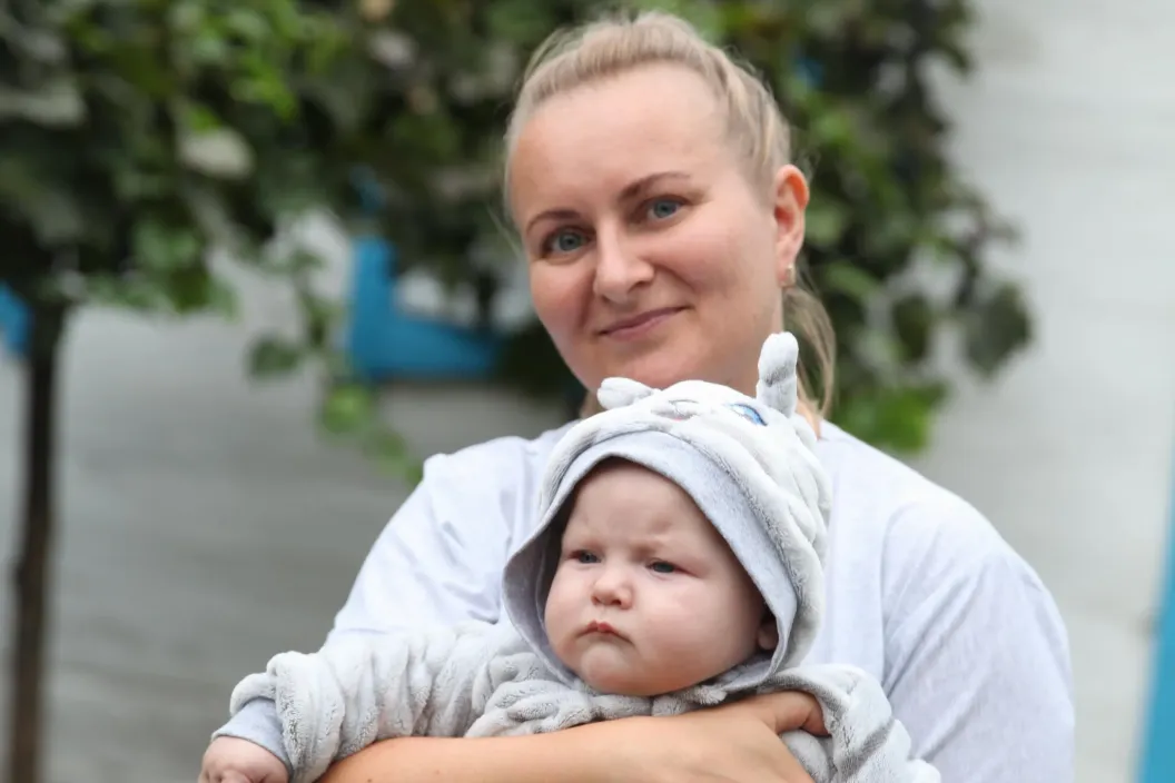 Woman holding baby.
